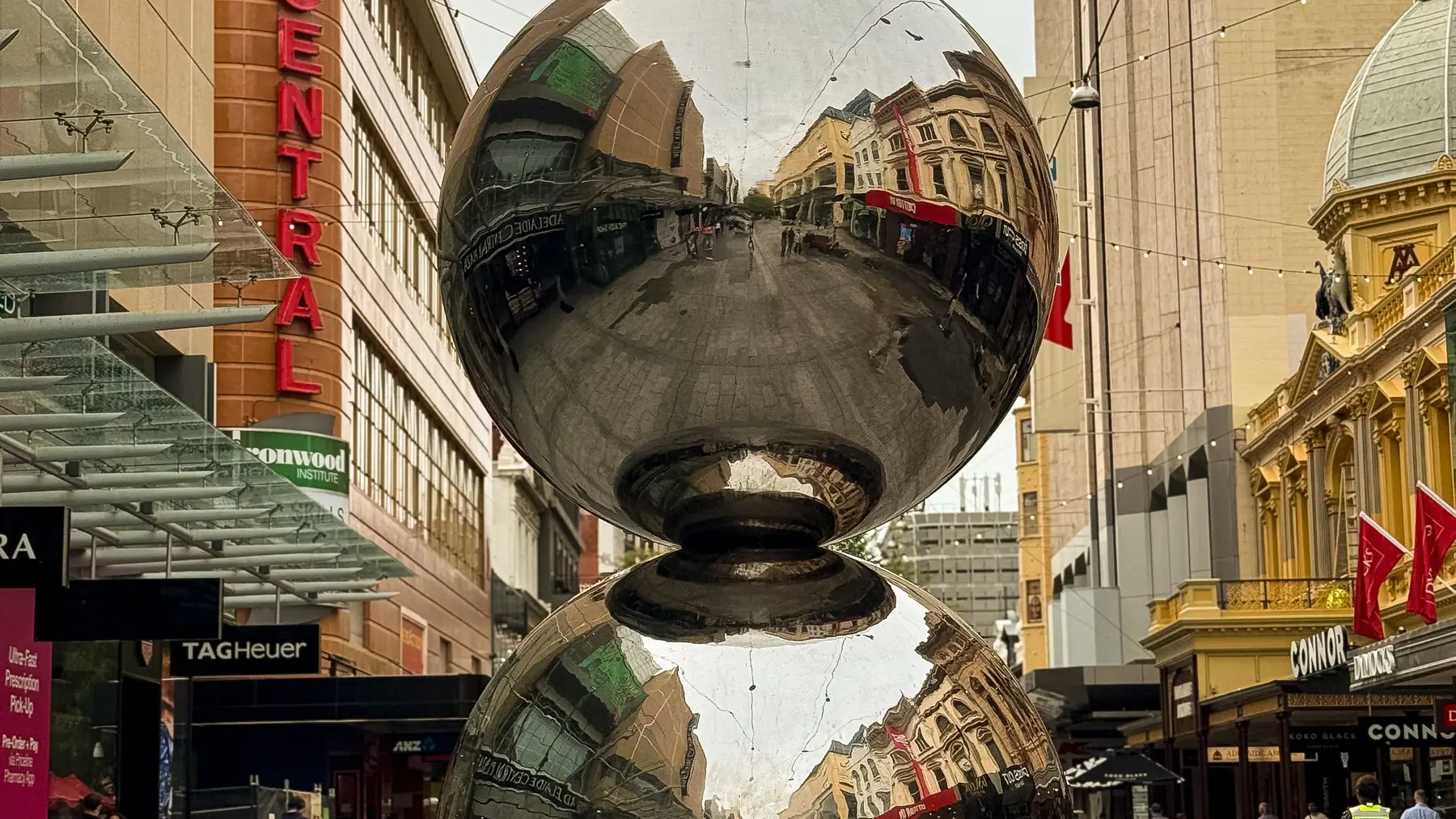 The reflective Mall’s Balls sculpture between shops on Rundle Mall, Adelaide