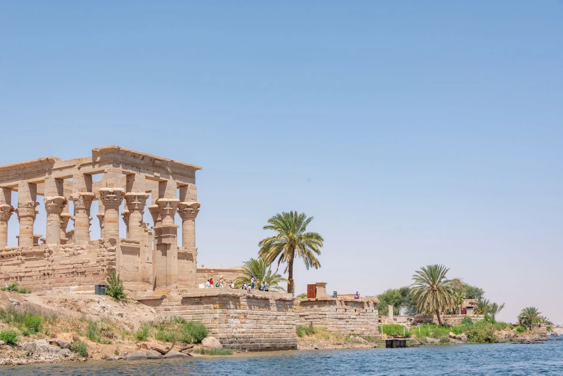 Trajan’s Kiosk and palm trees at Philae on Agilkia Island, seen from the water