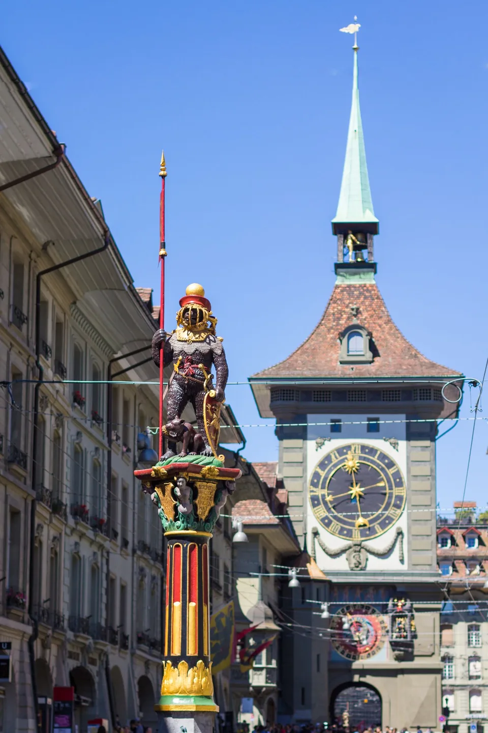 The Zytglogge clock face and a painted fountain figure in Bern