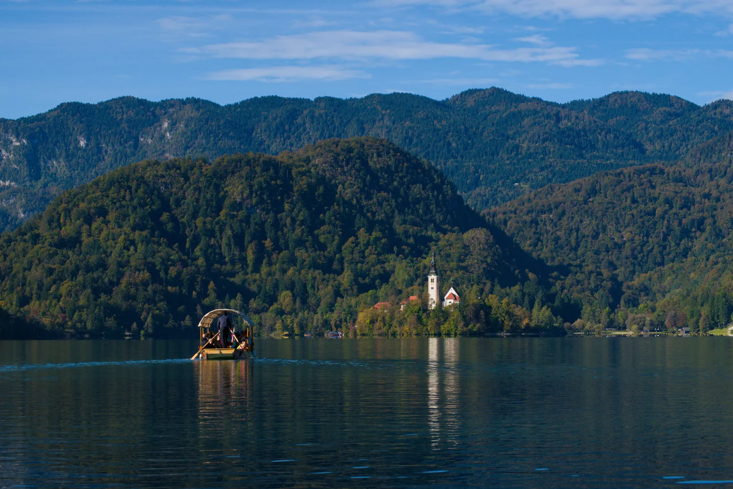 A traditional pletna boat on Lake Bled with the island church behind