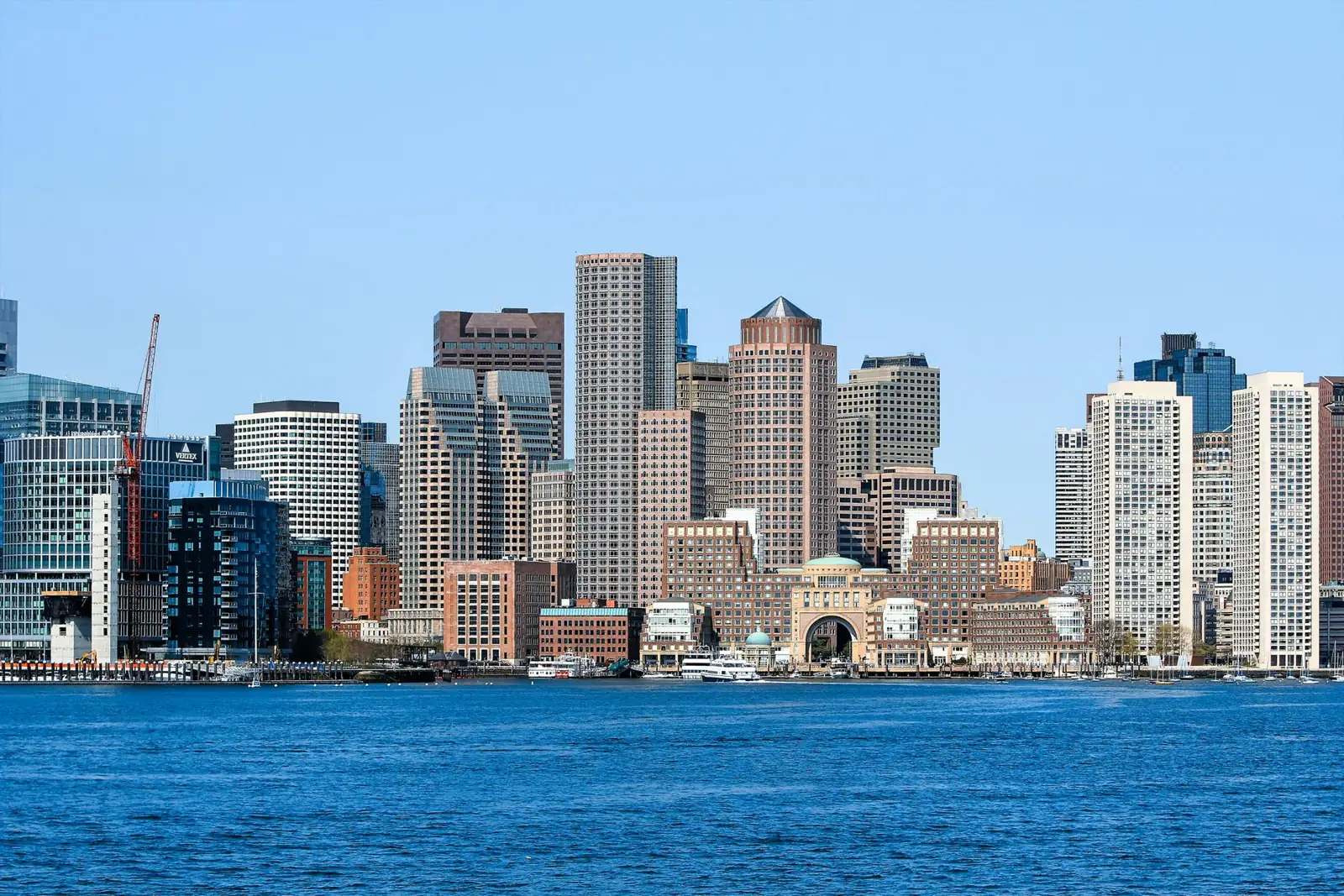 Boston’s downtown waterfront skyline with the Rowes Wharf arch and harbor boats