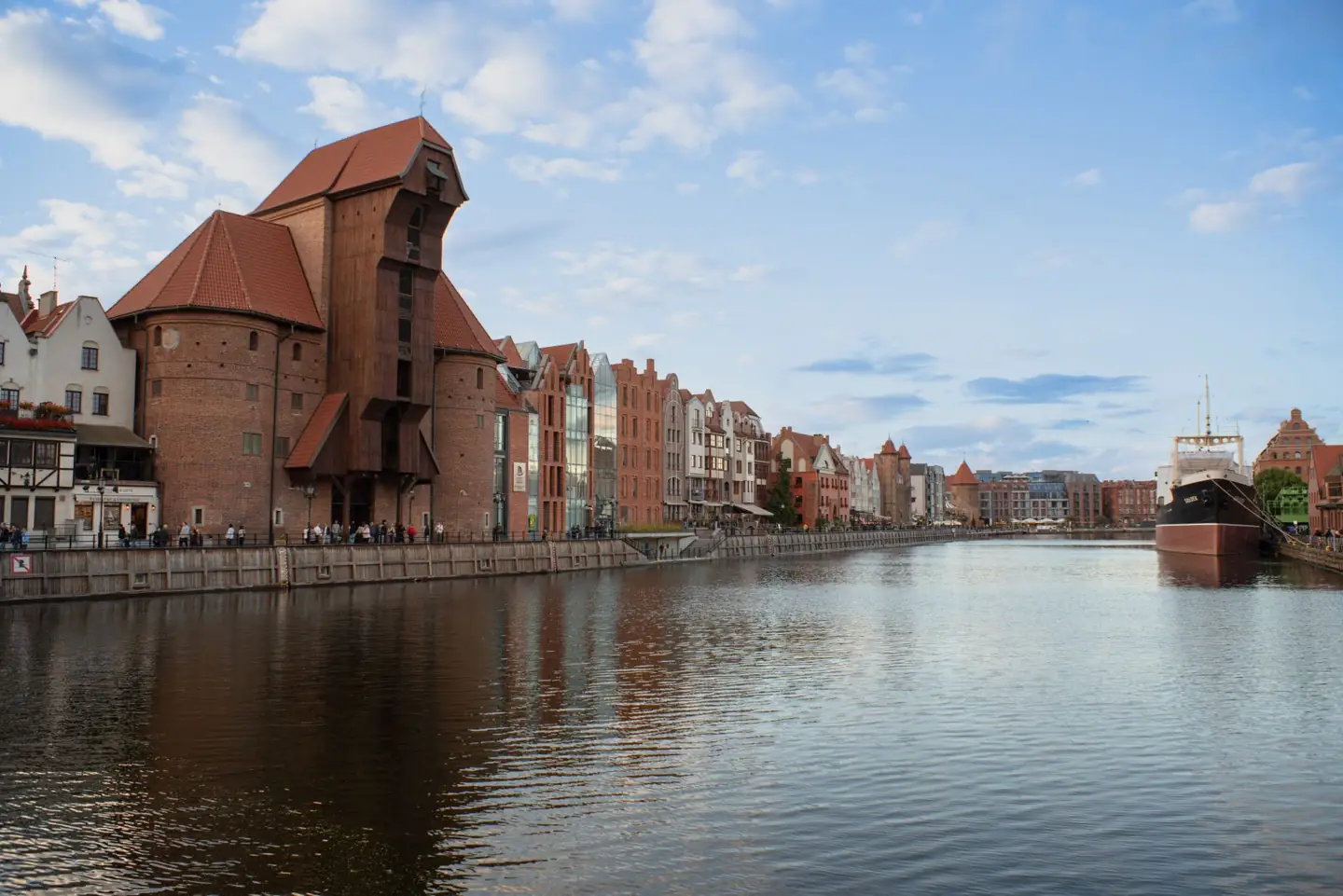 The medieval Crane on Gdańsk’s Motława waterfront, with its projecting timber lifting structure above the river