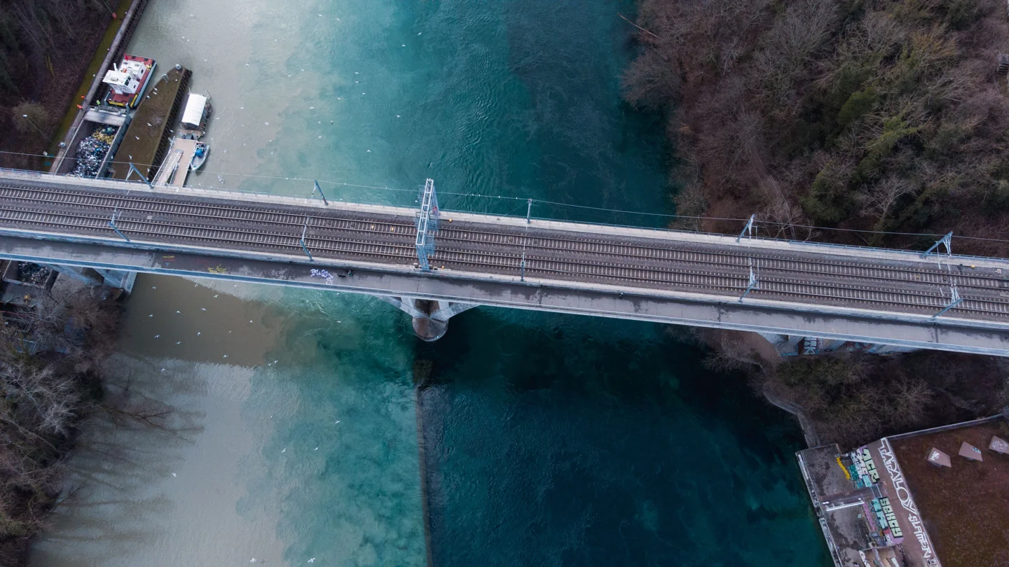 The railway and pedestrian Jonction viaduct above the contrasting Rhône and Arve waters in Geneva