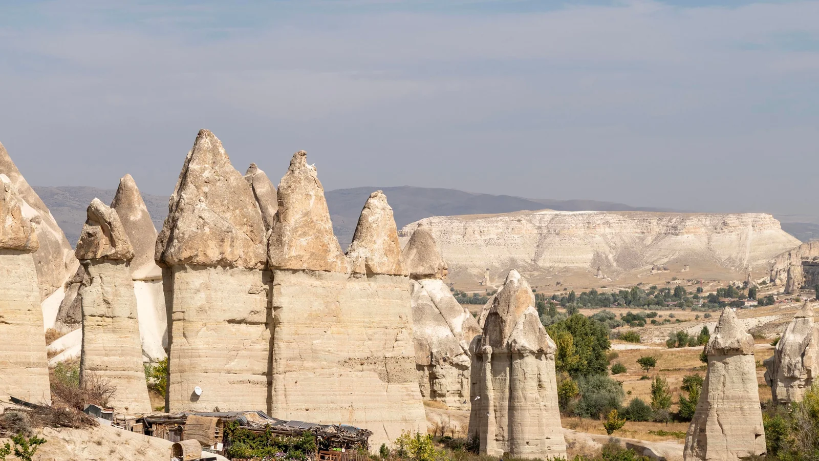 Tall, pale fairy chimneys with pointed caps in Cappadocia’s Love Valley near Göreme.