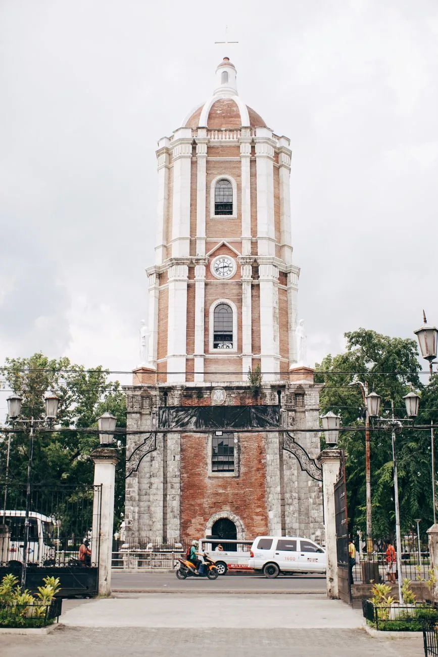Jaro Belfry’s clock and pale upper storeys rising above its brick base in Iloilo City