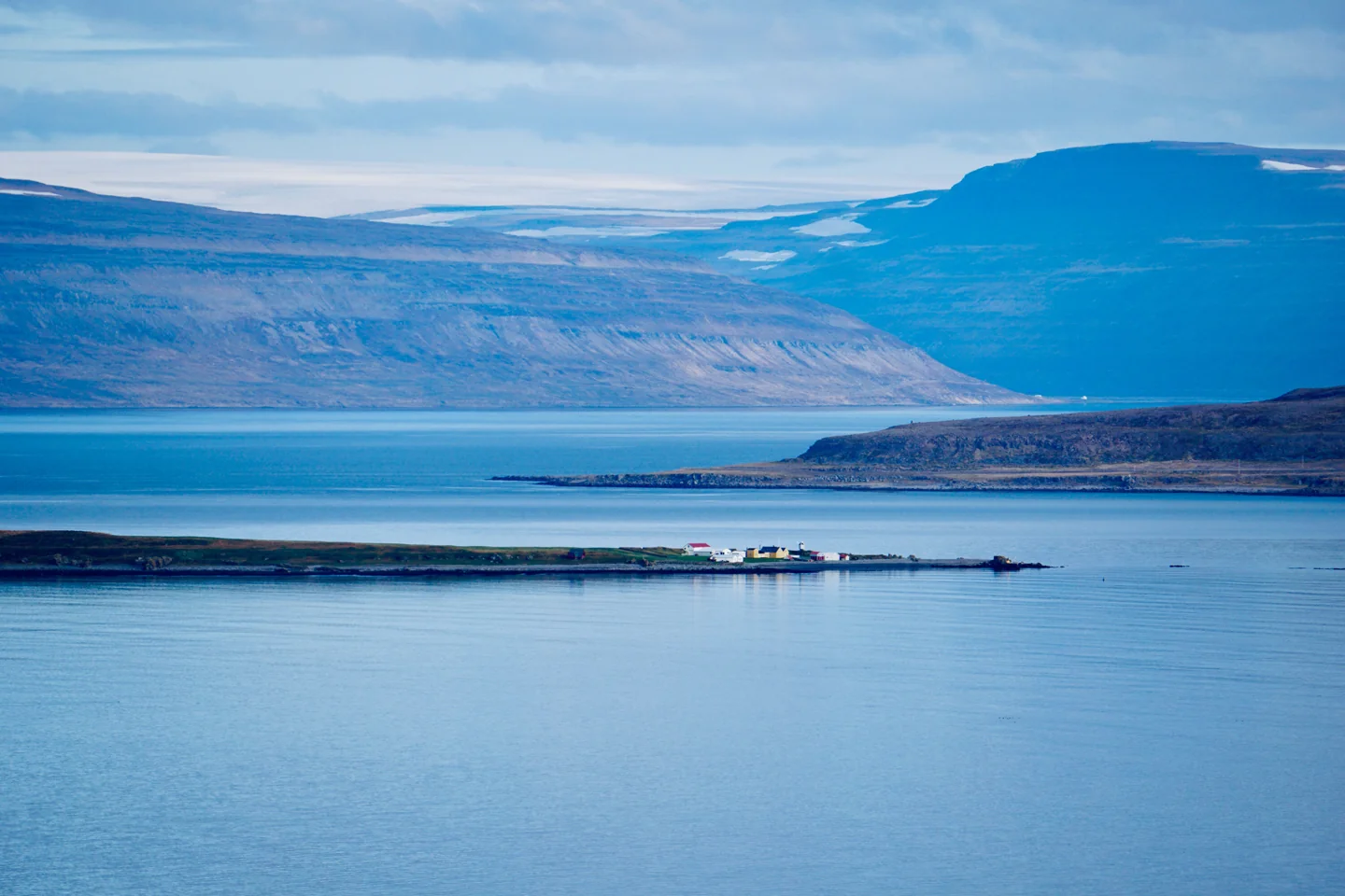 Vigur Island’s low shoreline, colourful farm buildings and windmill in Ísafjarðardjúp