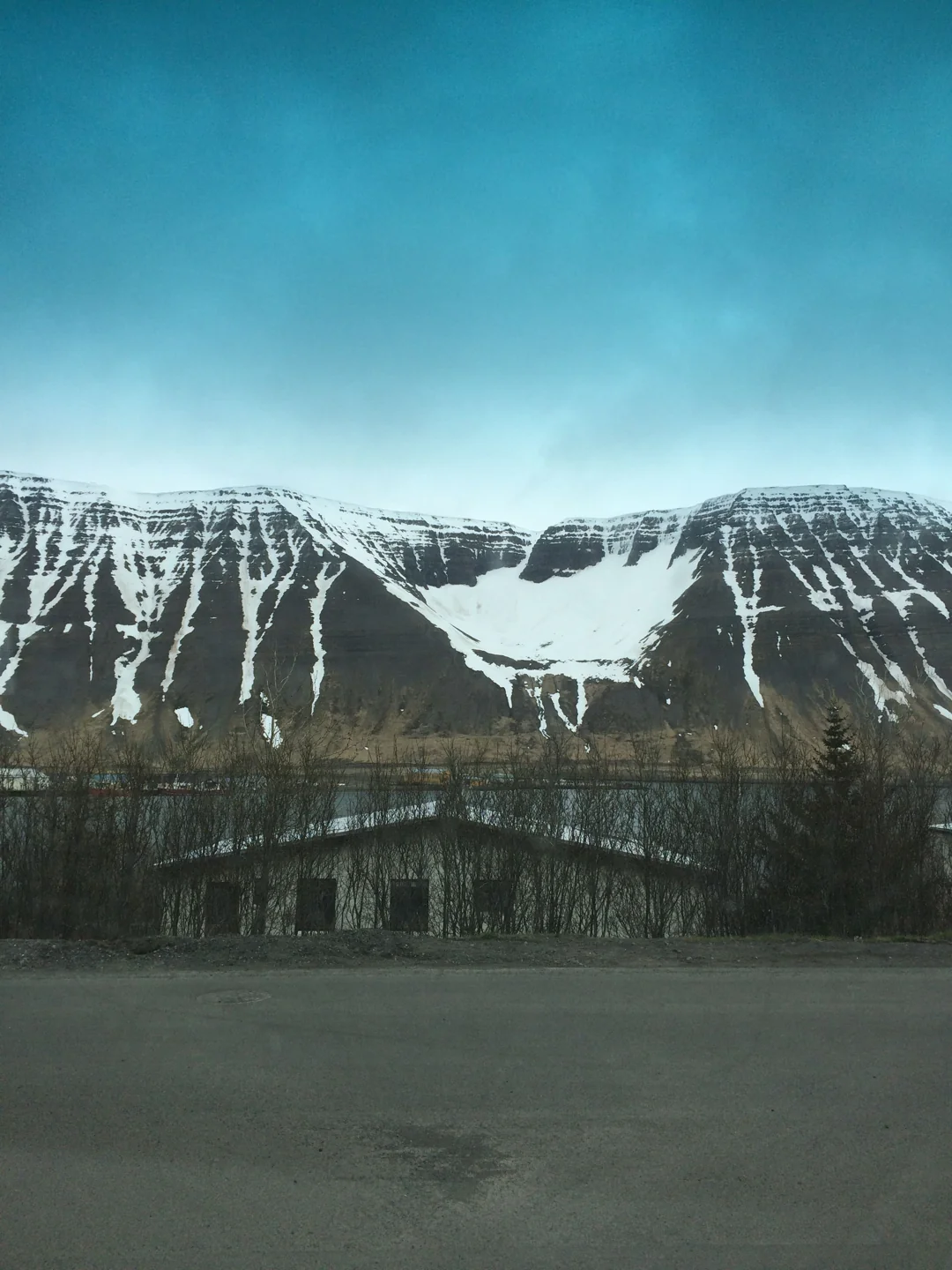 Snow-striped cliffs and the mountain cirque above the Ísafjörður fjord setting