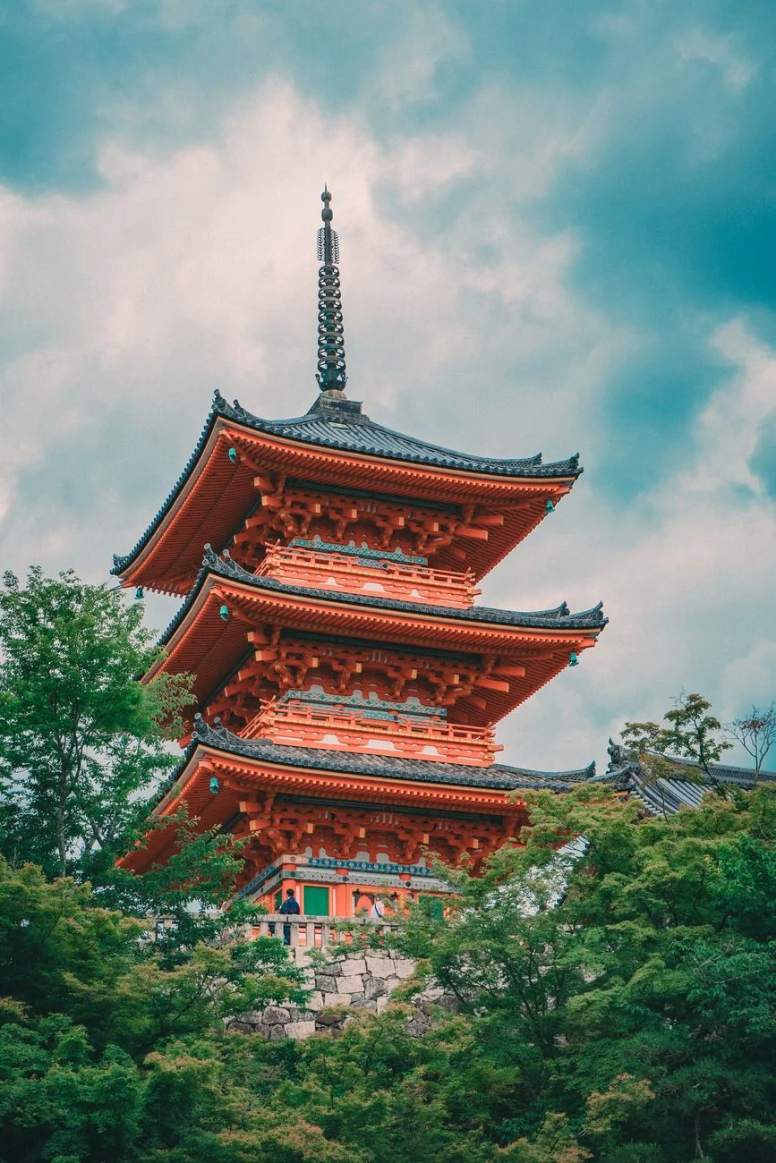The vermilion pagoda at Kiyomizu-dera surrounded by greenery