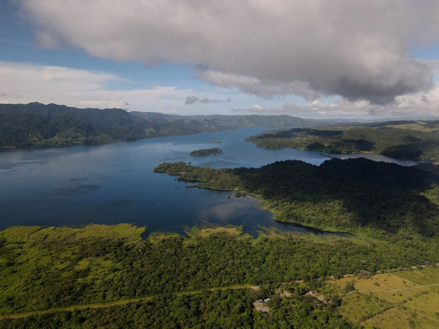 Lake Arenal’s branching shoreline and forested peninsulas beneath cloud