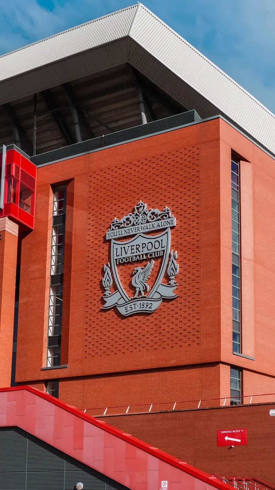 Liverpool FC crest on the red exterior of Anfield stadium
