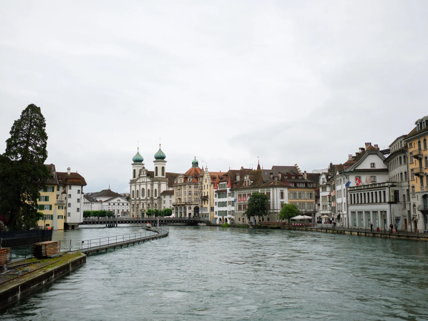Historic Lucerne buildings and the Jesuit Church alongside the River Reuss