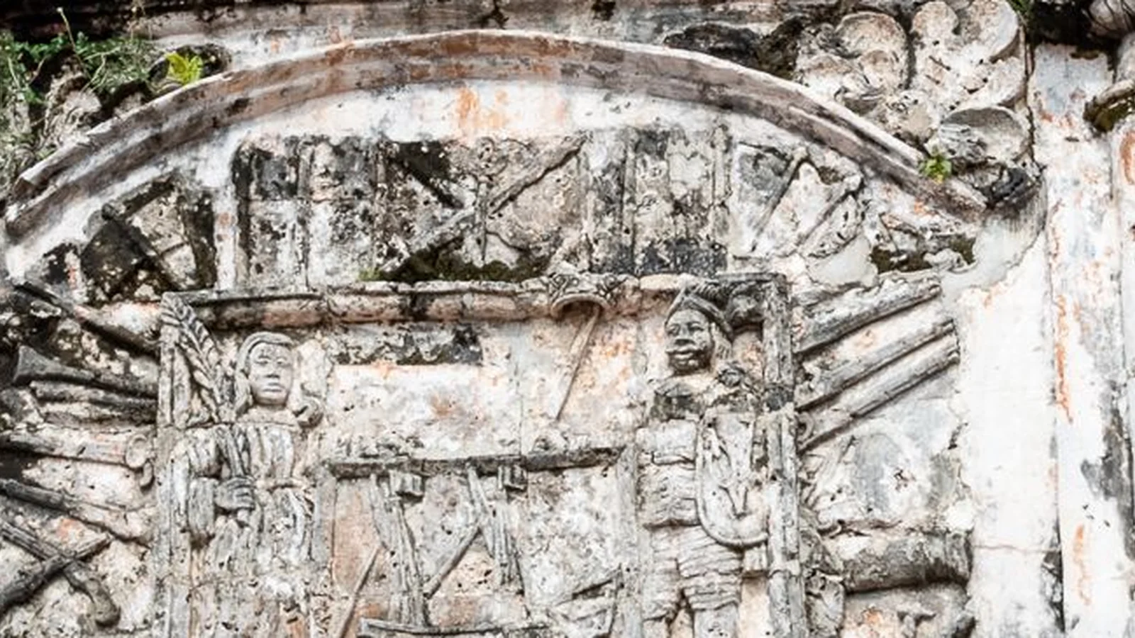 A close view of the weathered carved relief above the A Famosa gateway in Malacca.