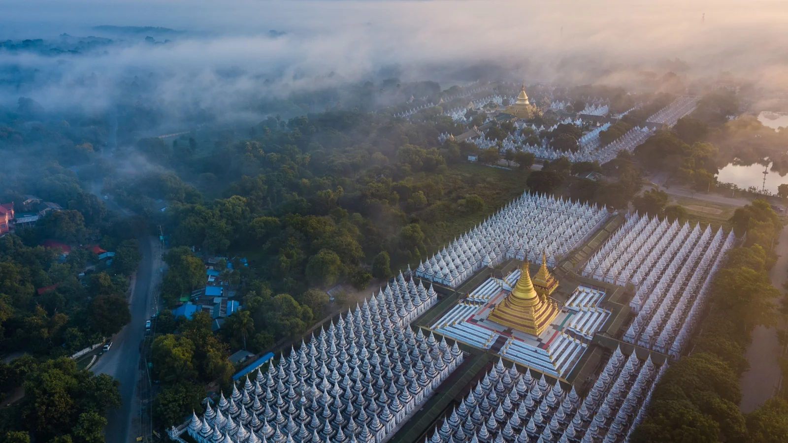 Sandamuni Pagoda’s compact rows of white inscription shrines surrounding a golden stupa, with Kuthodaw’s more widely spaced compound beyond.