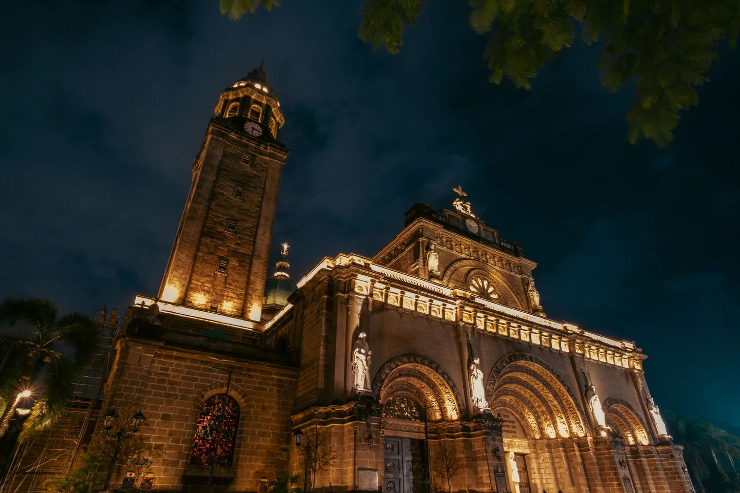 Manila Cathedral and its bell tower illuminated against the night sky