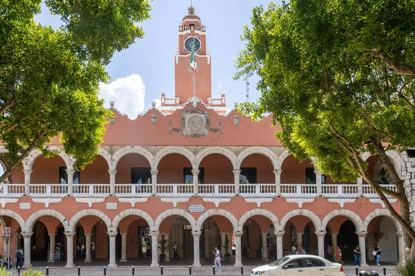 Red arcades and central clock tower of Mérida’s Palacio Municipal beside Plaza Grande
