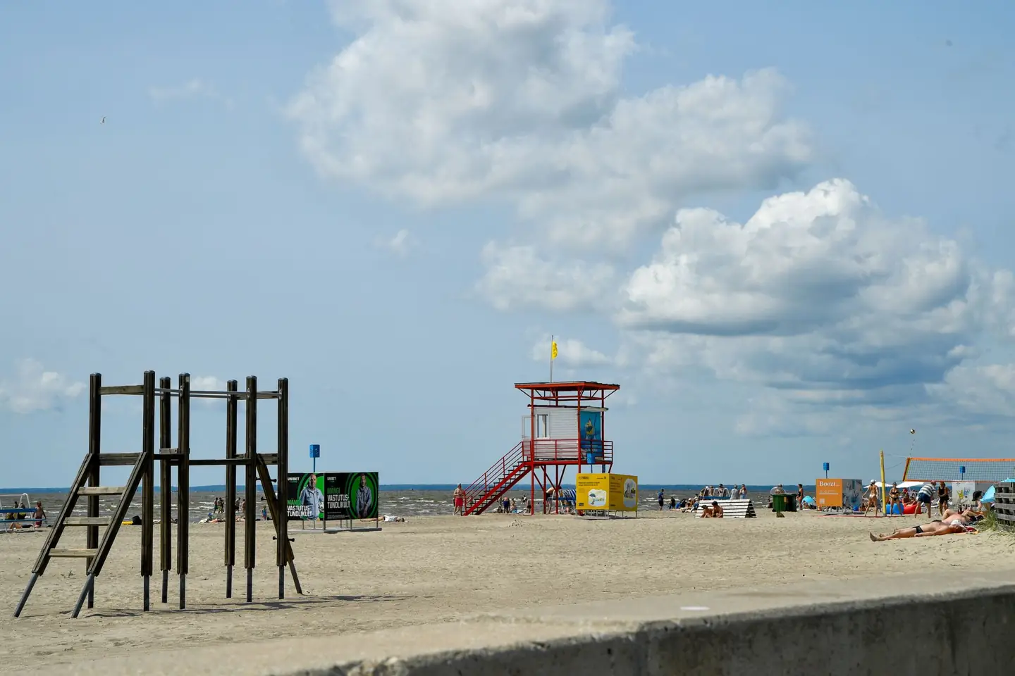 Pärnu Beach’s sand, outdoor exercise structure and red lifeguard tower on a summer day
