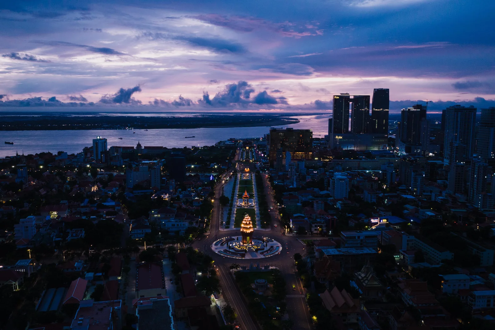 Phnom Penh’s illuminated skyline and riverfront at twilight.