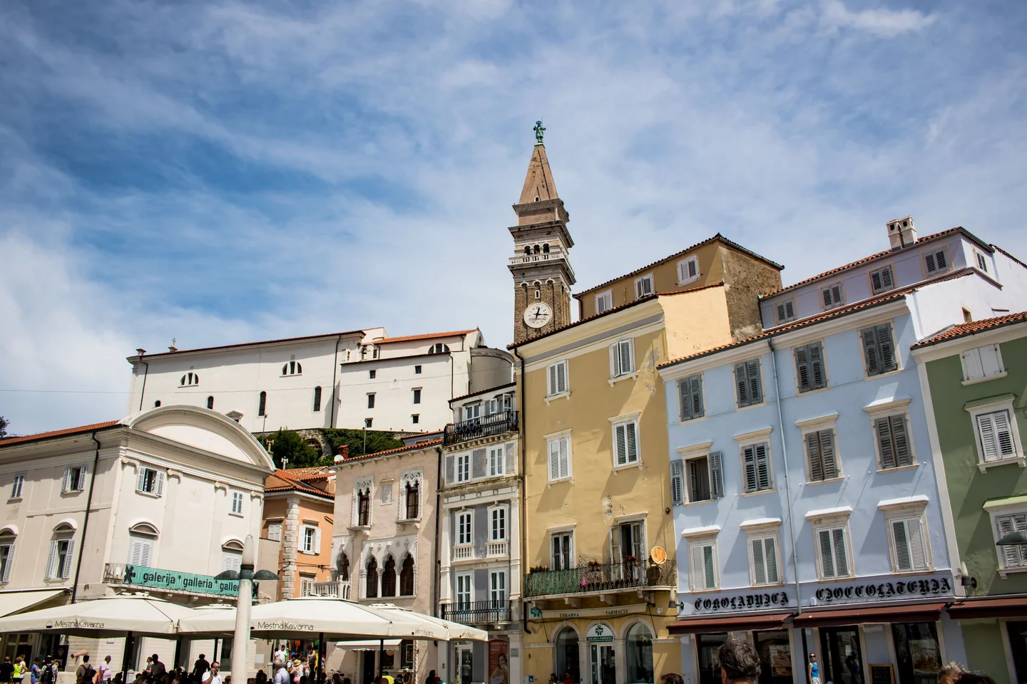 Historic facades around Tartini Square beneath Piran’s St George’s bell tower