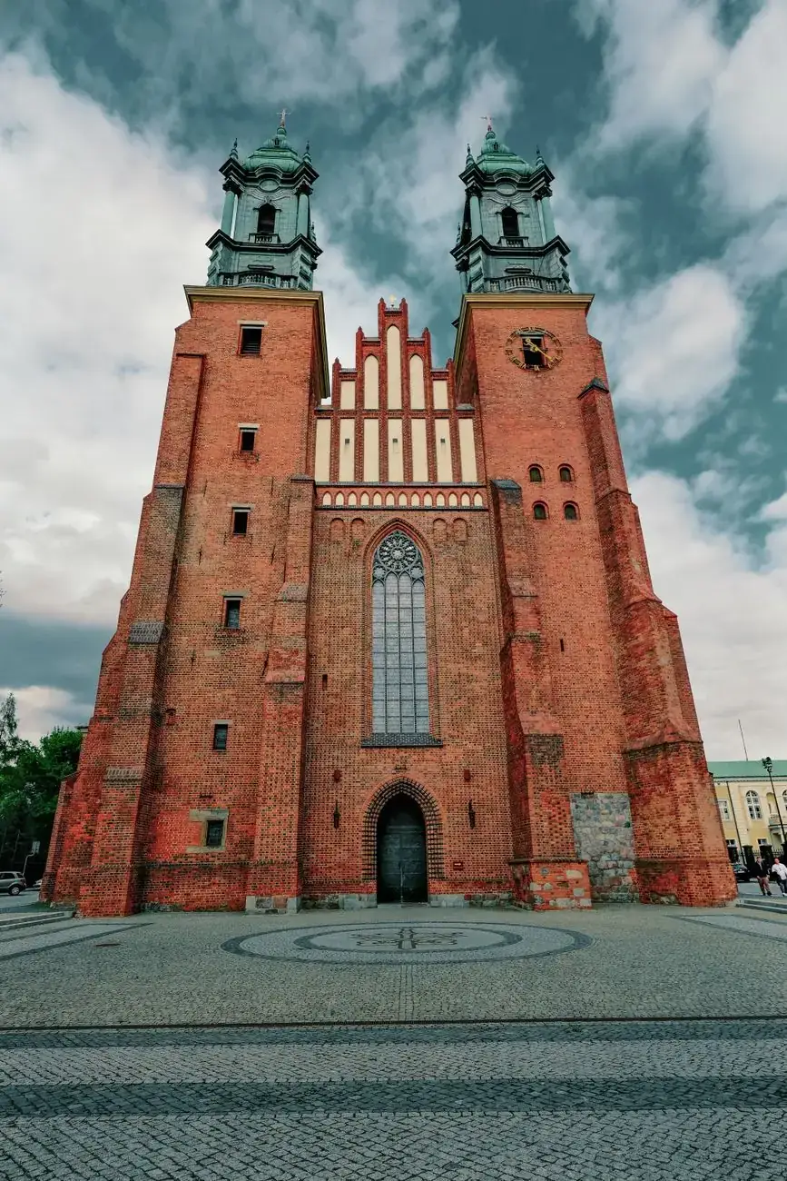 Poznań’s Cathedral of Saints Peter and Paul with twin brick towers, green copper roofs and a stepped central gable