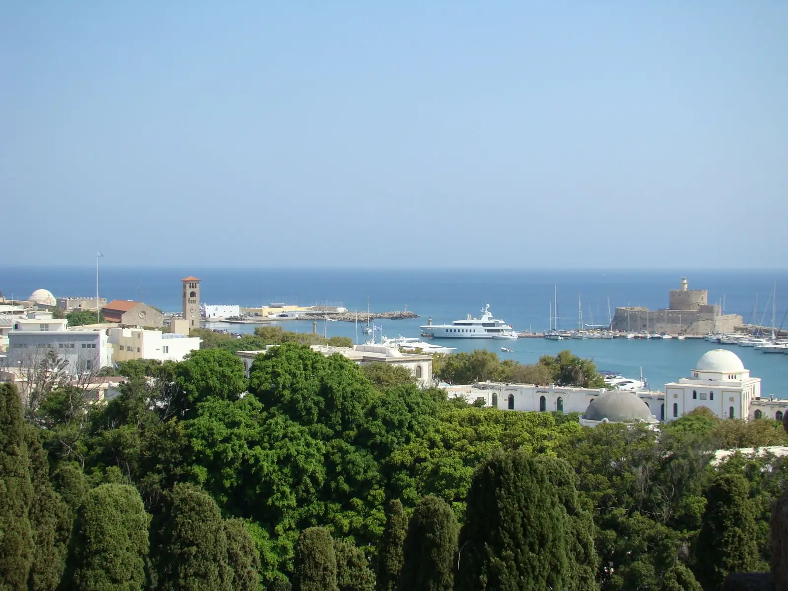 Mandraki harbour with St Nicholas Fort and boats in Rhodes