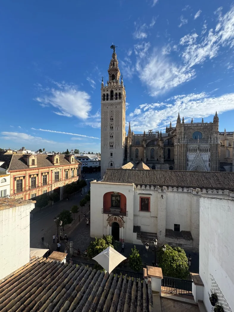 Seville Cathedral and the Giralda tower under a blue sky