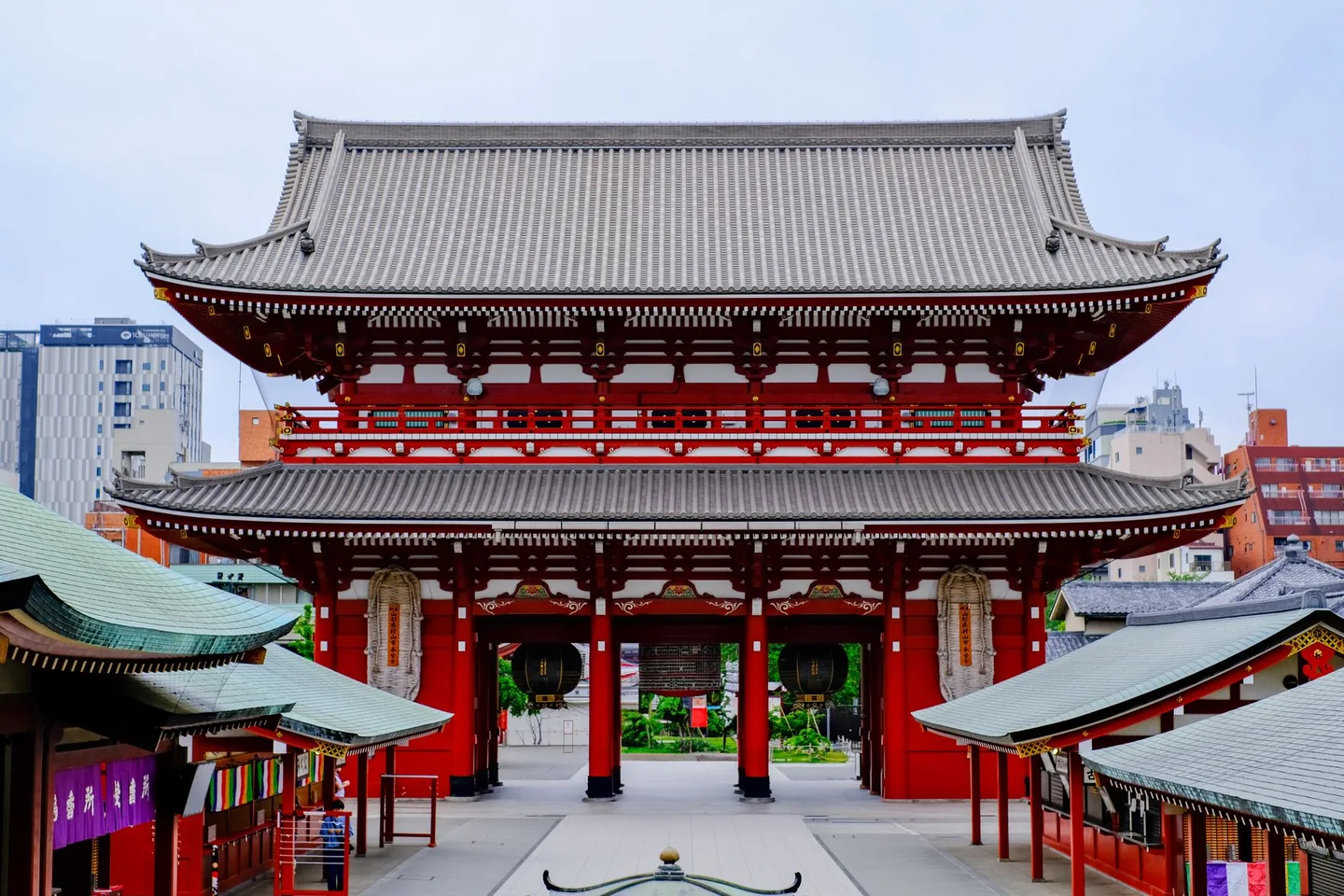 The red Hozomon gate at Senso-ji above the roofs of Nakamise shops