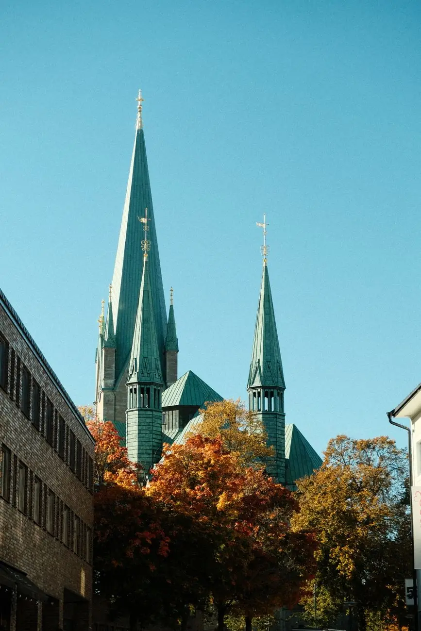 Nidaros Cathedral’s green spires above autumn trees