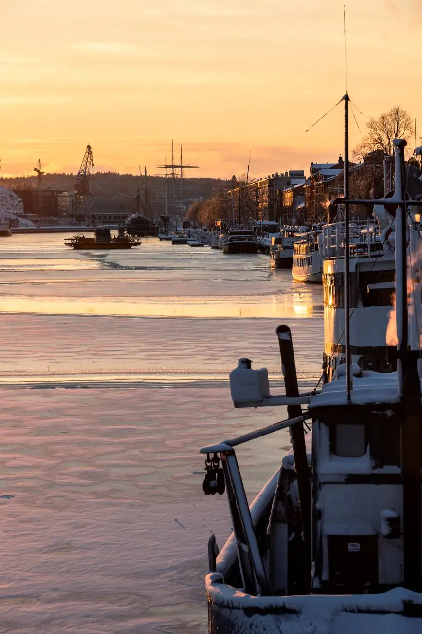 Museum ships beside Turku’s lower Aura River at sunset