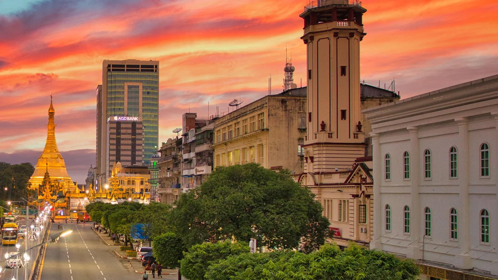 Sule Pagoda and downtown Yangon streets beneath a colourful sunset.