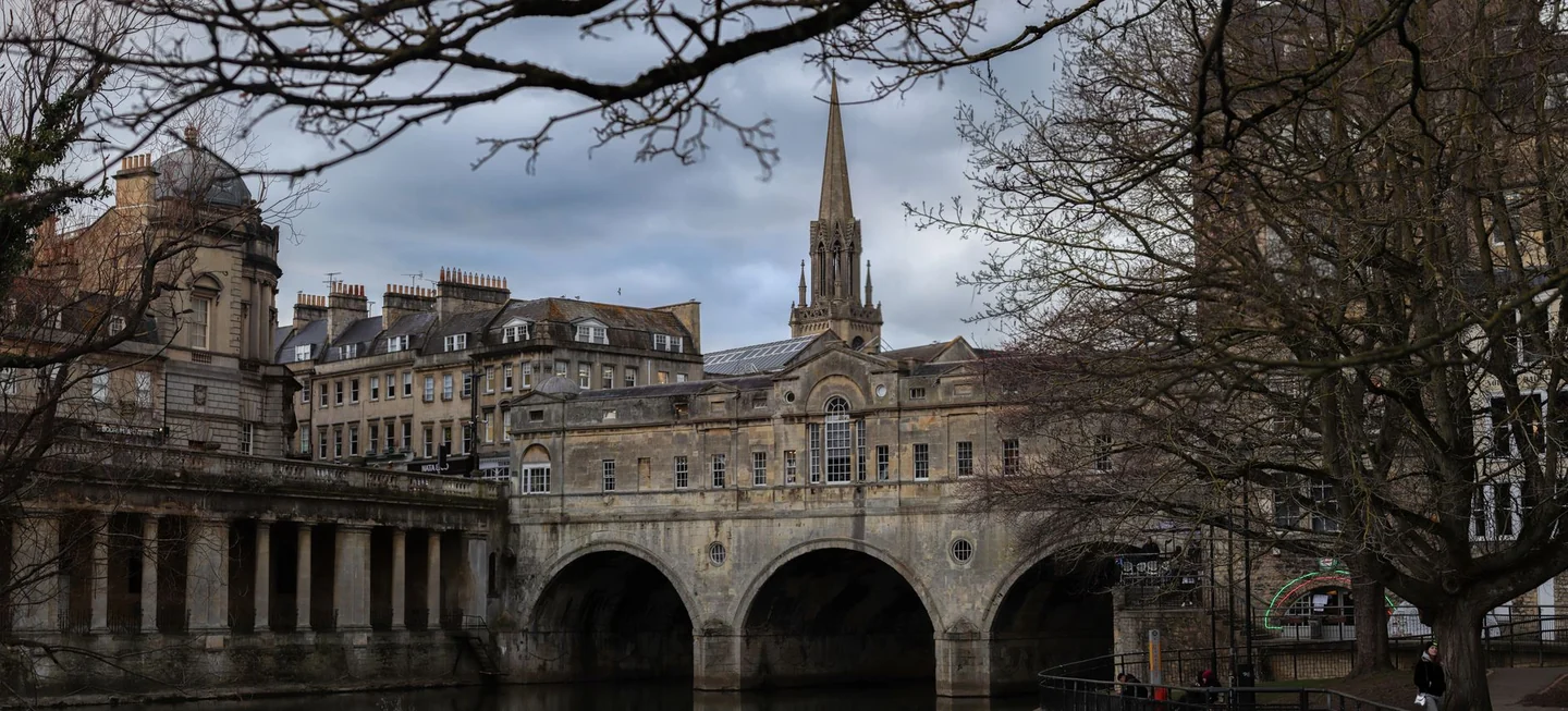 Pulteney Bridge and the River Avon in Bath, framed by winter trees