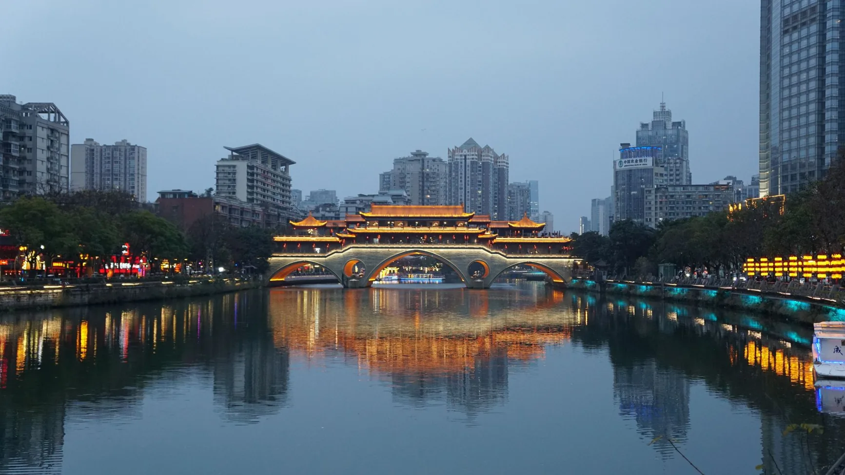 Anshun Bridge illuminated above the Jin River in Chengdu at dusk