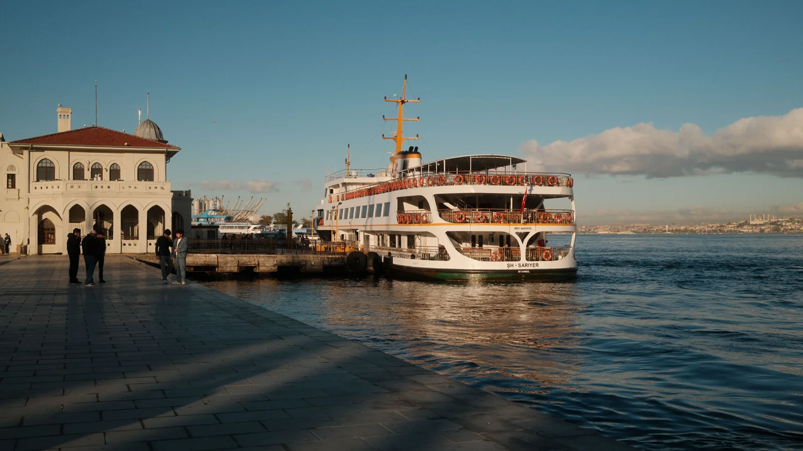A passenger ferry beside the historic Eminönü pier building on Istanbul’s waterfront.