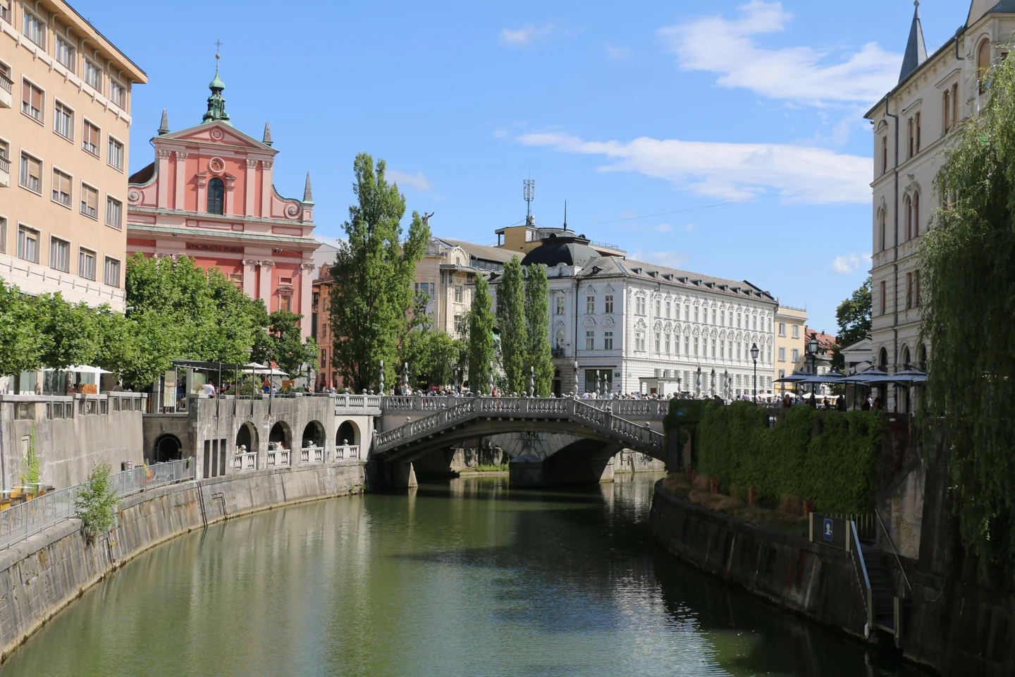 The pink Franciscan Church and Triple Bridge beside the Ljubljanica in Ljubljana