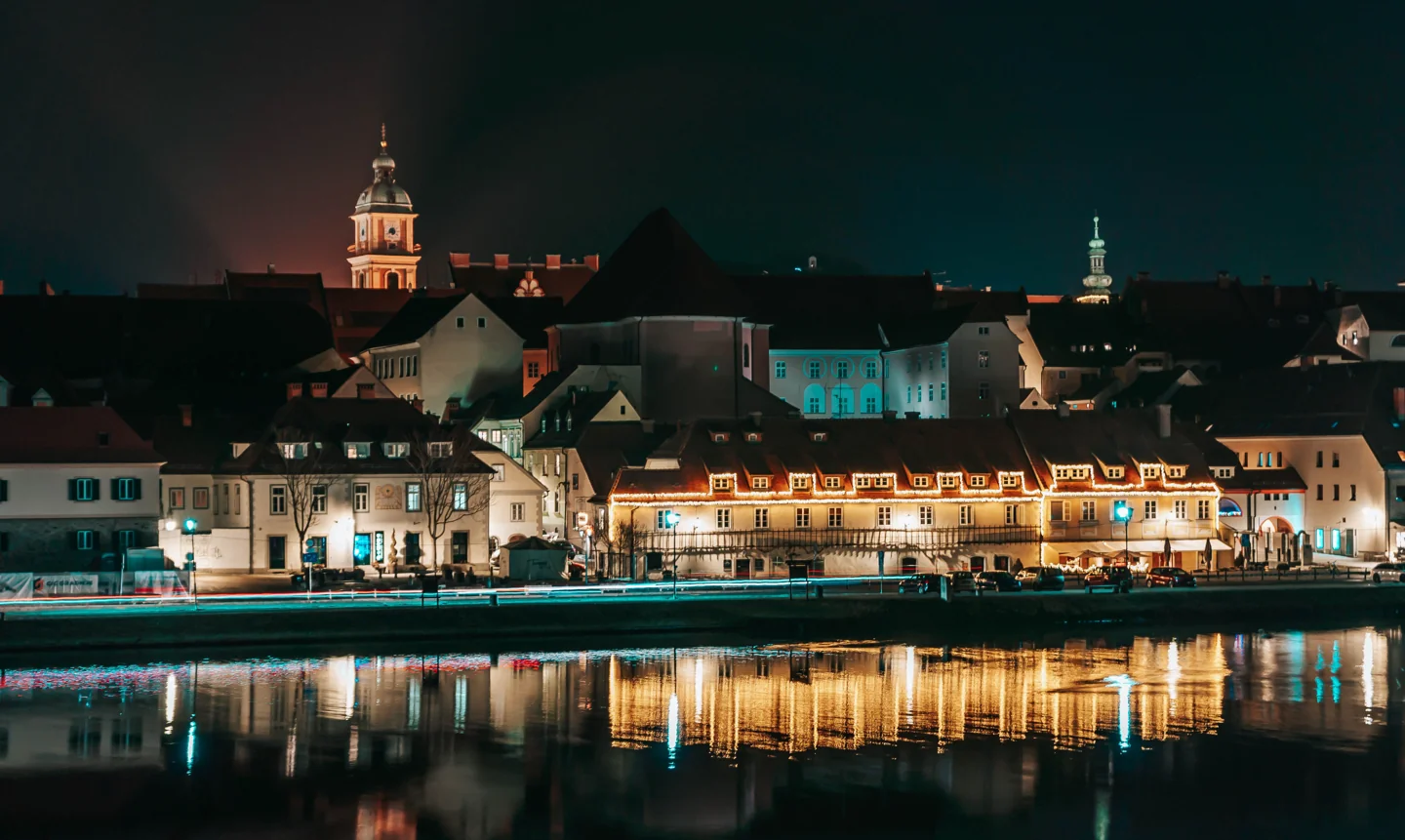 Maribor’s Lent riverfront and the Old Vine House illuminated beside the Drava at night