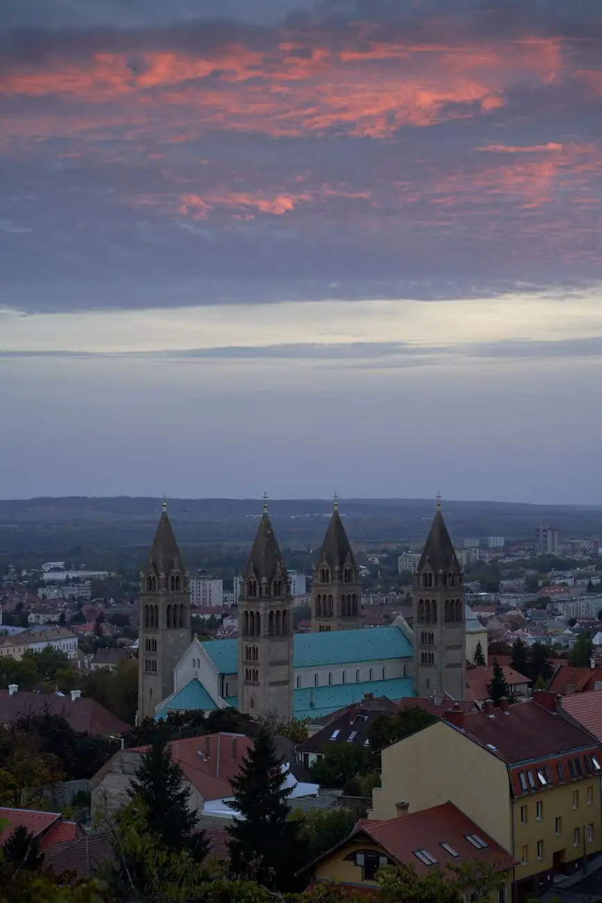 Pécs Cathedral’s four square towers above the city rooftops at dusk