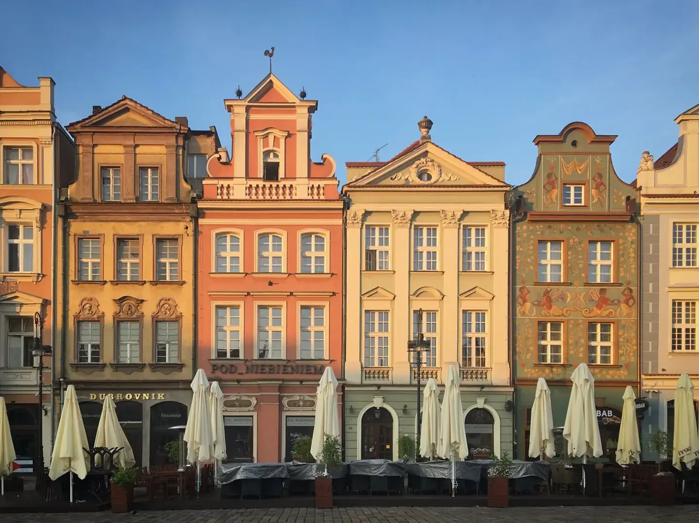Colourful historic tenement façades around Poznań’s Old Market Square in daylight