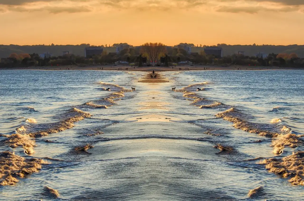 Waves and sand at sunset on Swansea Bay beach