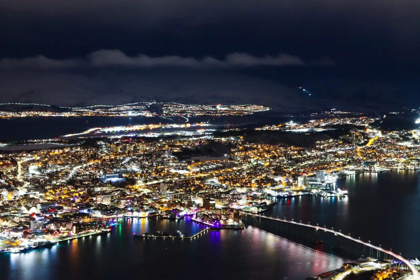 Tromsø’s illuminated island centre and bridge viewed from above
