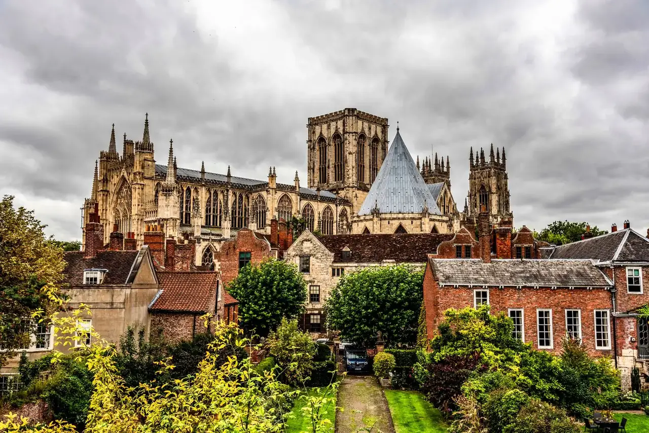 York Minster above the rooftops under a cloudy sky